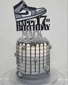 a birthday cake with a shoe on top and happy 17th birthday to the man in black