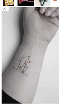 a small elephant tattoo on the wrist and in front of it is an image of two elephants