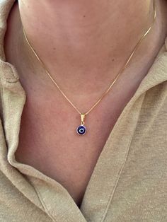 Dainty and waterproof, our Evil Eye necklace is the perfect everyday staple piece! Information: 🧿 18K Gold Filled (stamped) 🧿 Hypoallergenic 🧿 Tarnish Resistant 🧿 Waterproof Our Evil Eye necklace is carefully crafted with a high level of craftsmanship and attention to detail. For instance, you can see this in the high polishing of the necklace to the waterproof properties. The charm is dainty, around 6MM. The charm is reversible, you will be able to see the Evil Eye on both sides of the charm. If you would like a longer length than what is listed, chain extensions are available upon request free of charge. The Evil Eye 🧿 is known as a talisman of protection against evil energies, keeping the wearer safe from harm. This necklace makes a great gift. Blue Evil Eye Necklace, Evil Eye Necklace Gold, Protection Necklace, Blue Evil Eye, Eye Pendant, Evil Eye Pendant, Evil Eye Charm, Evil Eye Necklace, Necklace Dainty