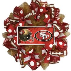 a football wreath with the san franciscos logo and polka dot bows on it's side