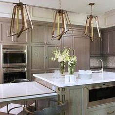 a large kitchen with an island, stove and oven in it's center area