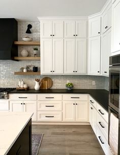 the kitchen is clean and ready for us to use it's white cabinetry