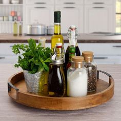 a wooden tray topped with bottles and spices