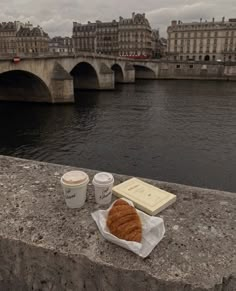 coffee and croissants on the edge of a bridge