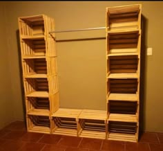 an empty closet with wooden shelves on the wall