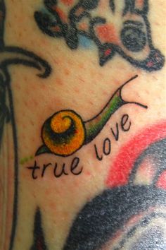 a close up of a person's arm with a tattoo on it that says true love