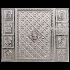 an intricately designed metal wall panel with ornate designs on the front and back panels