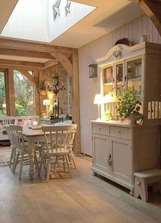 a dining room table and chairs in front of a window