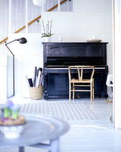 a room with a piano and chair in it