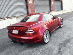 a red sports car parked in front of a building