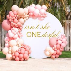 a sign that says isn't she onederful surrounded by pink and white balloons