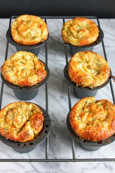 six muffins sitting on top of a metal rack