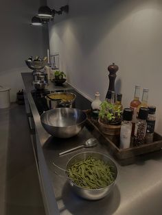 a kitchen counter topped with lots of bowls and pans filled with food on top of it