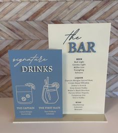 two greeting cards with drinks on them sitting next to each other