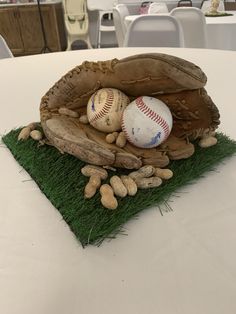 a baseball mitt with nuts and a ball in it on top of a table