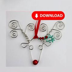 a red ribbon is attached to a silver wire reindeer ornament with bells and beads