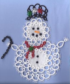 a snowman made out of crochet on a blue background with black beads