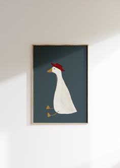 a white duck with a red hat on it's head is framed in a wall