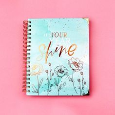 a spiral notebook with the words it's your year to shine written on it