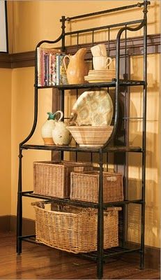 a shelf with baskets and dishes on it