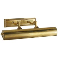 a brass bathroom light with two lights on each side and an arm that is attached to the wall