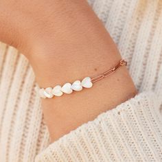 It's okay to blush -- our Pearl Heart Paperclip Chain Stretch Bracelets is just that cute! Combining an open-link rose gold chain with a stretchy strand of Mother Of Pearl heart beads, this slip-on style is the piece everyone's crushing on right now. Half of bracelet is a beaded with stretch elastic string, and the other half of bracelet is a paperclip chain. Paperclip chain: brass base with rose gold plating Mother of pearl heart beads: 7mm x 7mm Total length of bracelet: 6.75inches Heart Paperclip, Pura Vida Necklace, Costa Rica Pura Vida, Pride Bracelet, Pearl Heart, Handcrafted Bracelets, Rose Gold Chain, Pave Ring, It's Okay