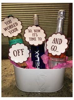 two bottles of wine in a bucket with signs