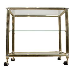 a metal and glass shelf with wheels