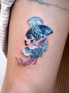 a woman's arm with a tattoo on it that has jellyfish in the water