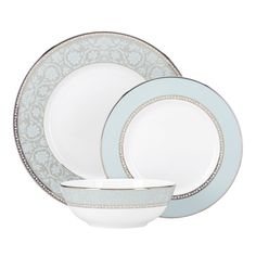 an image of a white and blue dinnerware set with silver trimmings on it