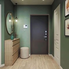 a hallway with green walls and wooden floors