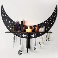 a shelf that has various items on it and is hanging from the wall with a candle