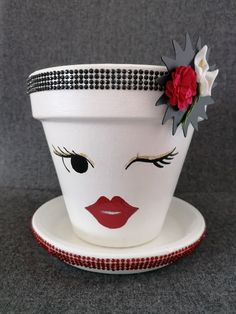 a white flower pot sitting on top of a saucer