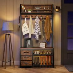 a coat rack with shoes, umbrellas and other items on it in a room