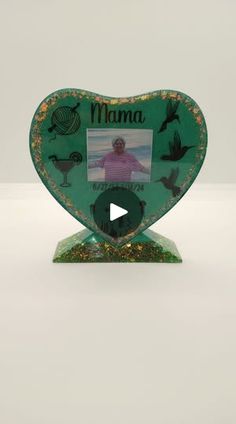 a heart shaped photo frame with an image of a man in the center and birds around it