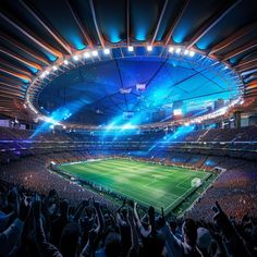 a stadium filled with lots of people watching a soccer game on the field at night