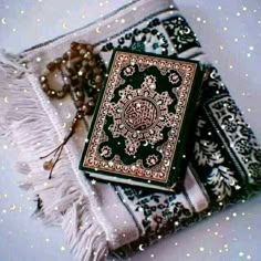 a green and white book sitting on top of a blanket