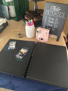 a table with a camera, cupcakes and a sign that says photo memories