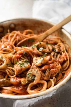 a pan filled with pasta and meat covered in sauce