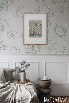 a bedroom with white walls and floral wallpaper