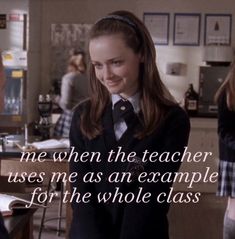 a girl in a school uniform is smiling and looking at another girl with her hand on her hip