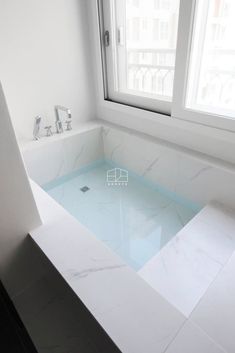 a bathtub in the middle of a white bathroom