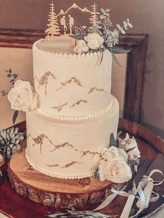 a three tiered wedding cake on top of a wooden table