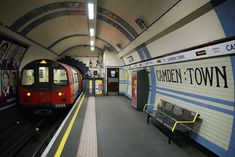 a subway train pulling into the station with its doors open