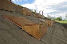 some wooden benches sitting on the side of a hill