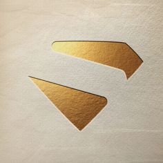 two gold arrow stickers on white paper