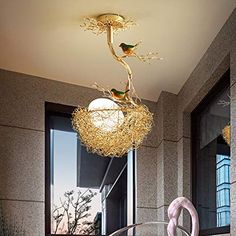 a chandelier hanging from the ceiling in a room with two birds on it