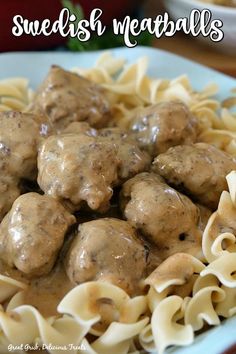 meatballs and noodles on a plate with gravy in the middle, ready to be eaten