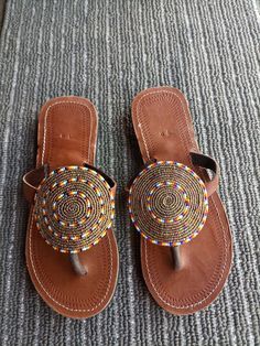 Unique Gift | Sandals | Gladiator Sandals | Greek Sandals | Beach Jewelry | Wedding Shoes | Leather Sandals | Custom | Mothers Gift An elegant and authentic pair of African inspired beaded ladies sandals, with a unique and eye-catching design. 100% genuine leather. Color - Multicolor.   *100%  Handmade.    S I Z E  C H A R T  EUUSAUKCMINCHES 343.51.522.38.8 354.52.5239 365323.69.3 376424.29.5 387524.99.8 398625.510 4096.526.110.3 4110726.810.6 4211827.510.8 4312928.211.1   ♥ you could also find Traditional Beaded Brown Flip Flops, Traditional Brown Beaded Flip Flops, Traditional Beaded Flip Flops With Round Toe, Traditional Brown Beaded Sandals, Traditional Beaded Sandals With Round Toe, Beaded Leather Sandals, African Sandals, Sandals Greek, African Beads Necklace