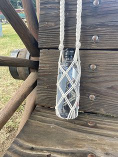 a water bottle tied to a wooden structure